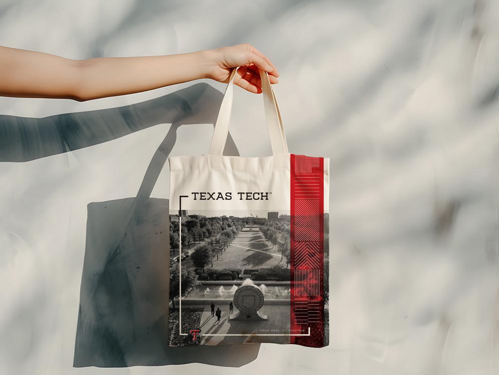 A canvas tote bag featuring a grayscale photo of campus.         There are overlaid decorative line elements, the Double T,         and the Texas Tech wordmark.