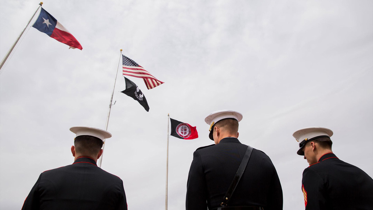 Veterans look at the American flag