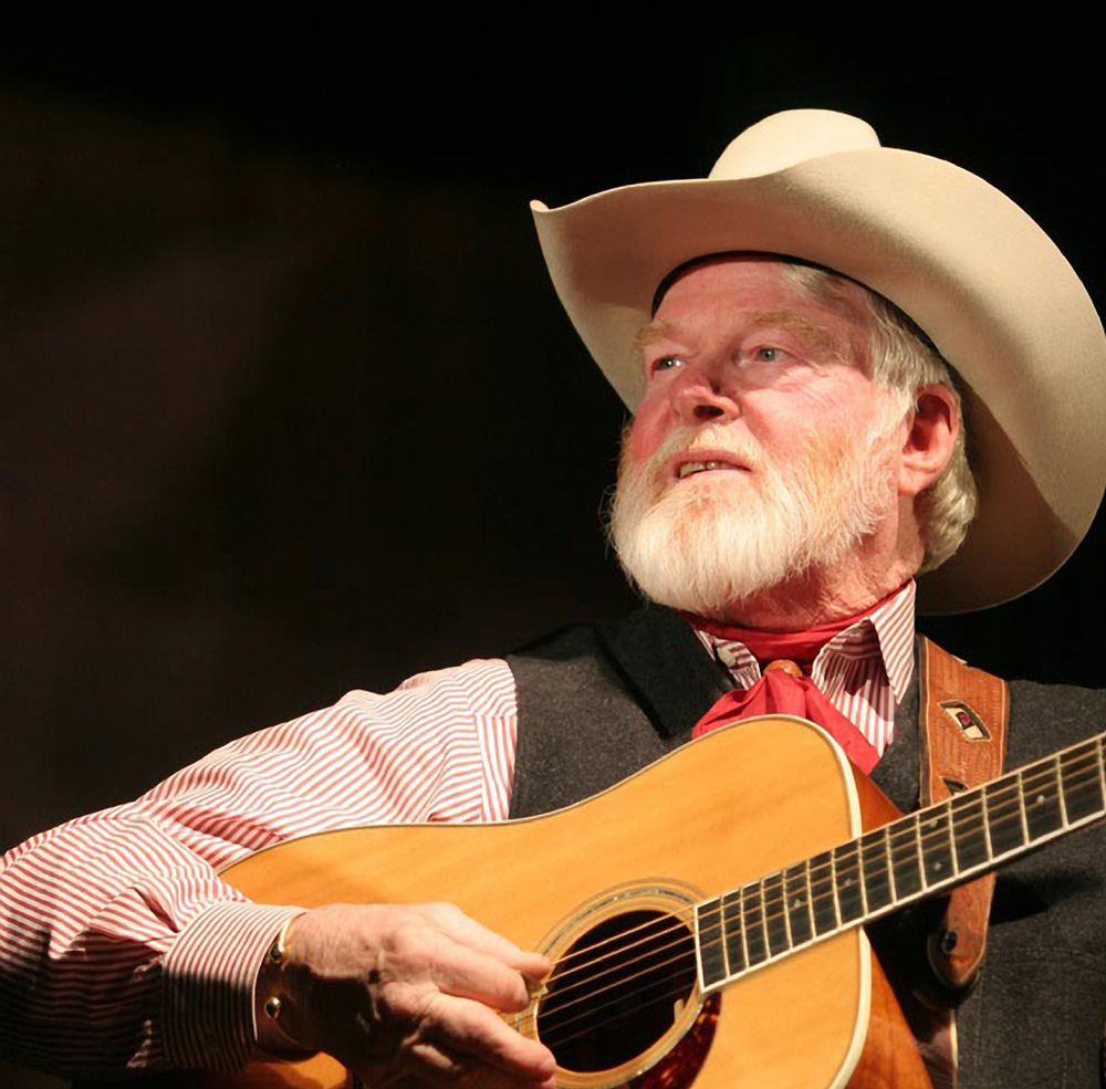 Bearded man plays guitar