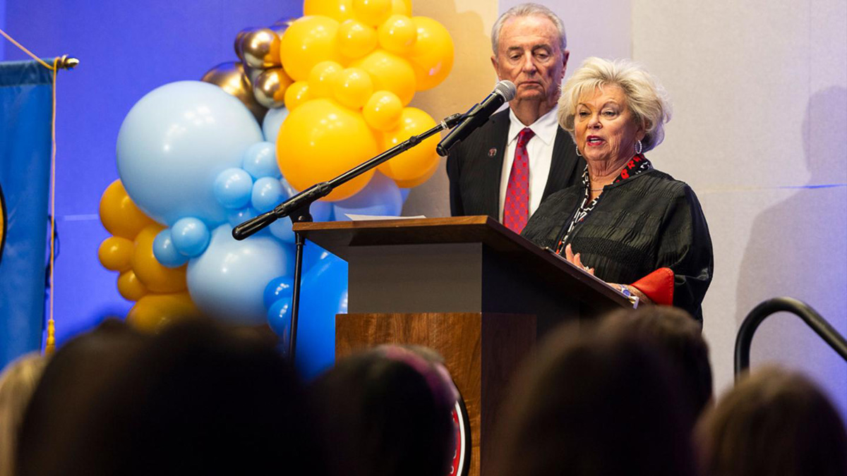 The Stricklings at a podium