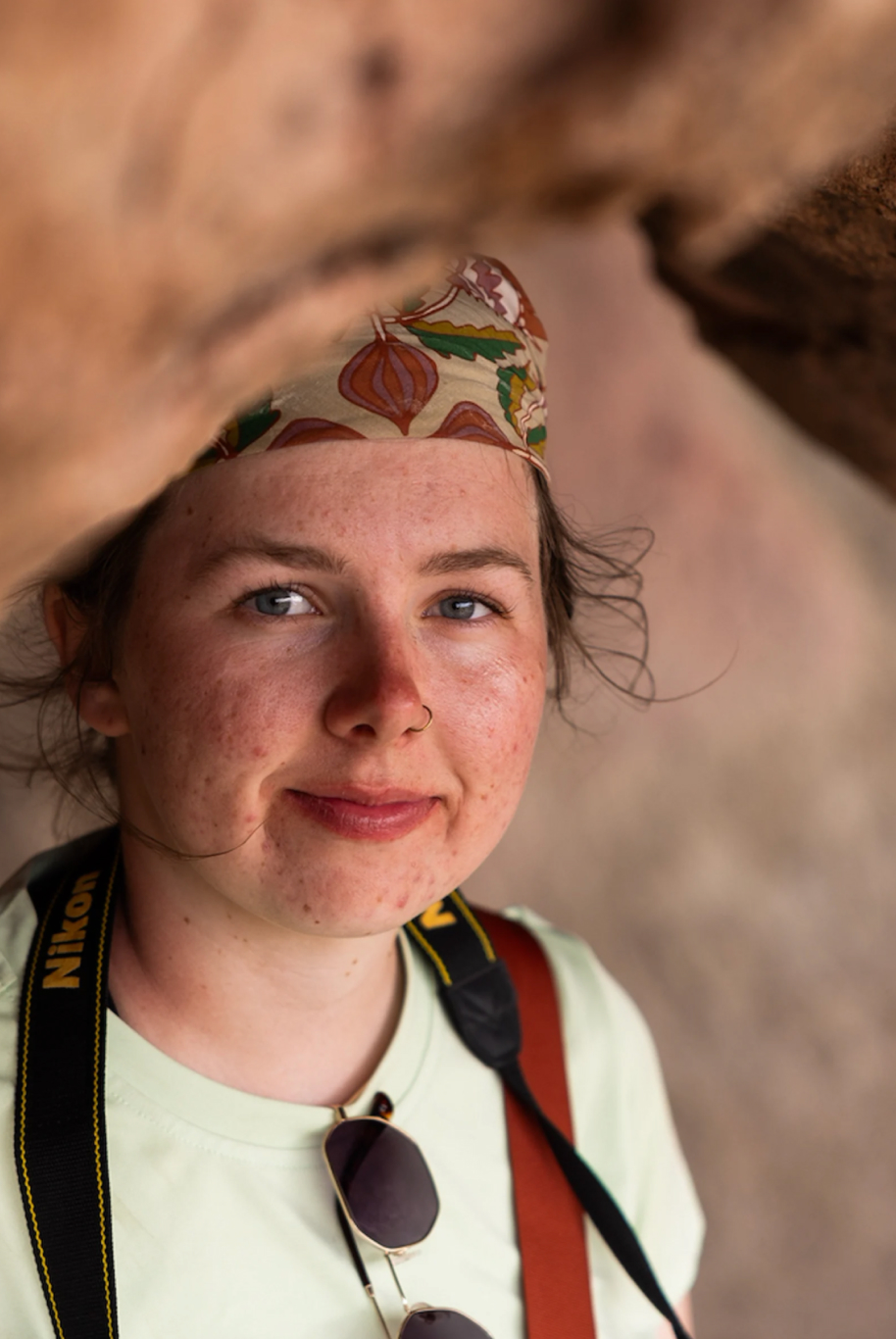 Photographer standing in a cave.