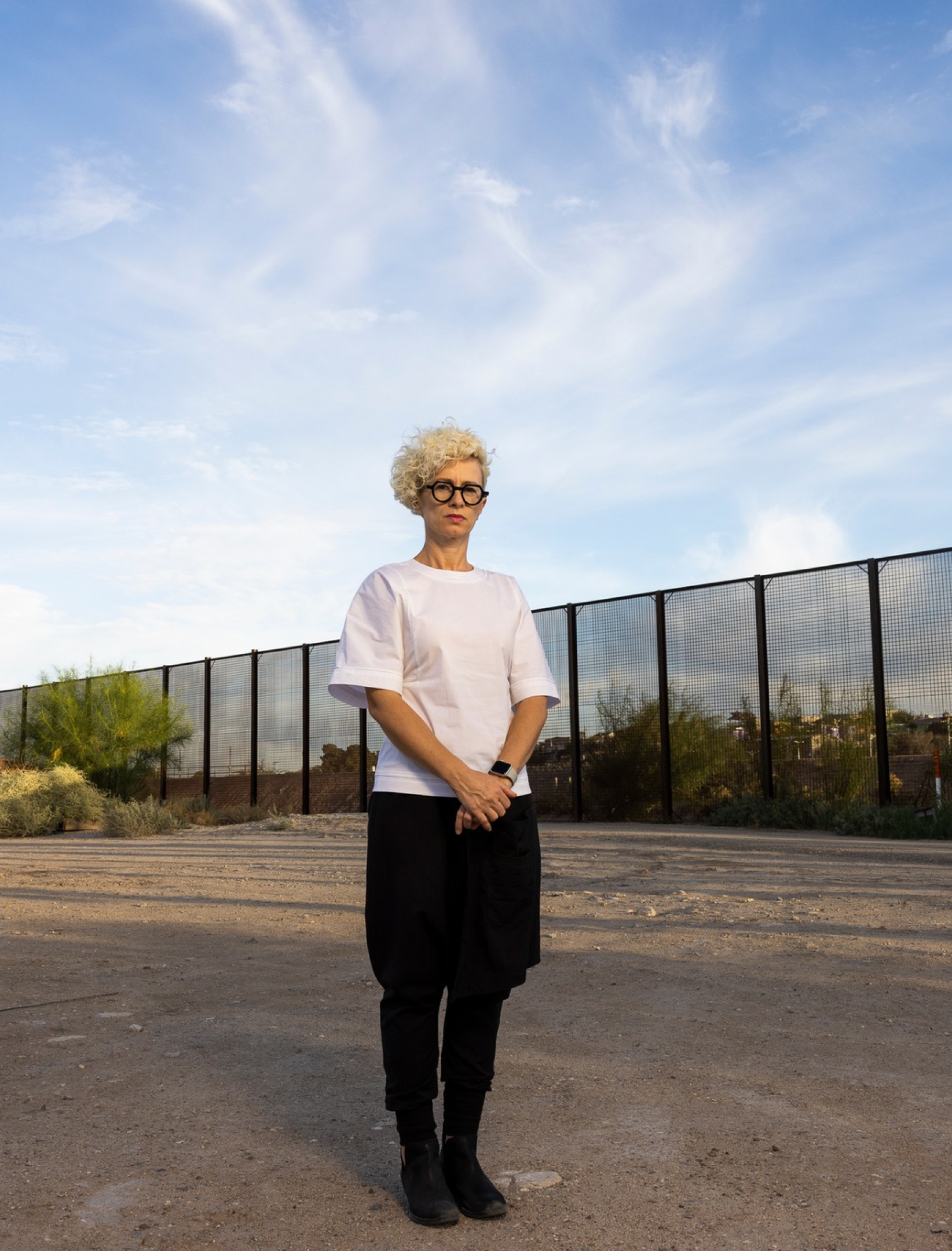 Woman stands in a parking lot