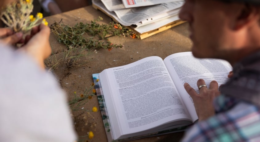 Man gestures at a book