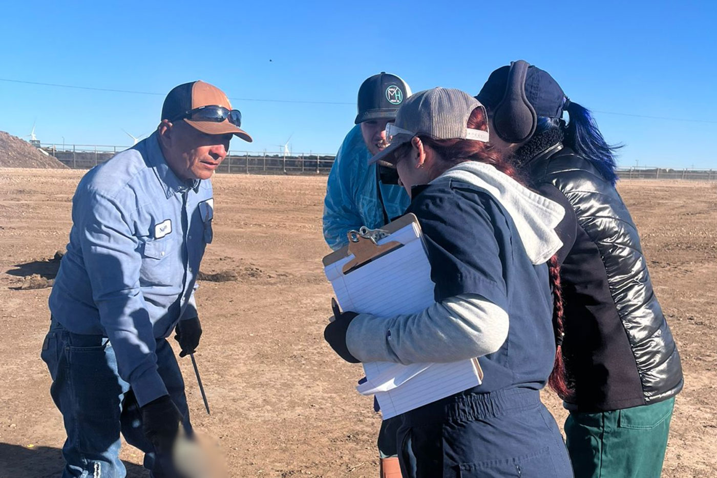 people standing in feedlot