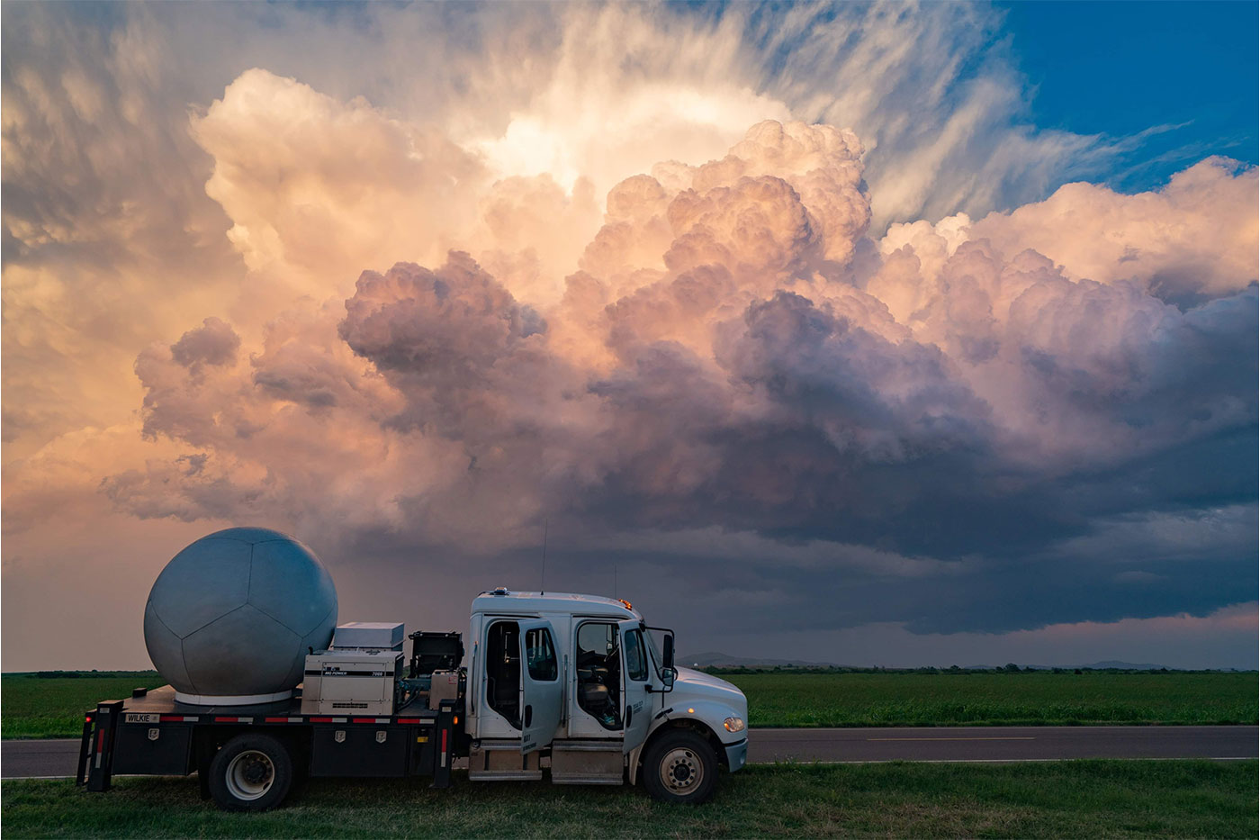 A Ka-band mobile radar truck is parked in front of an oncoming storm. Image courtesy of Alex Schueth