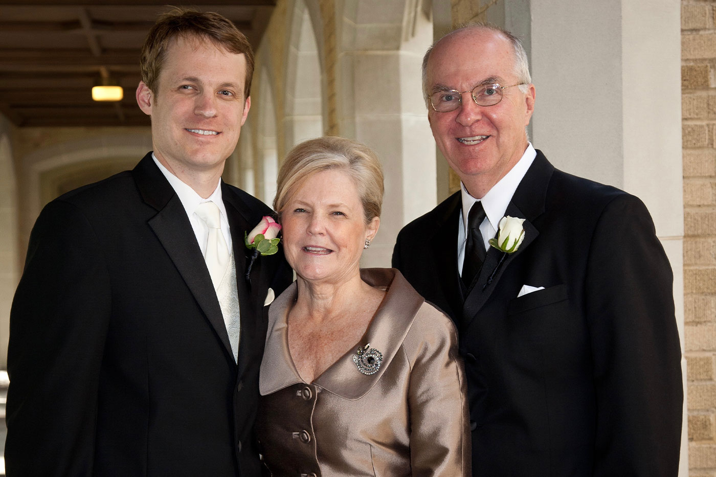 John with parents at wedding